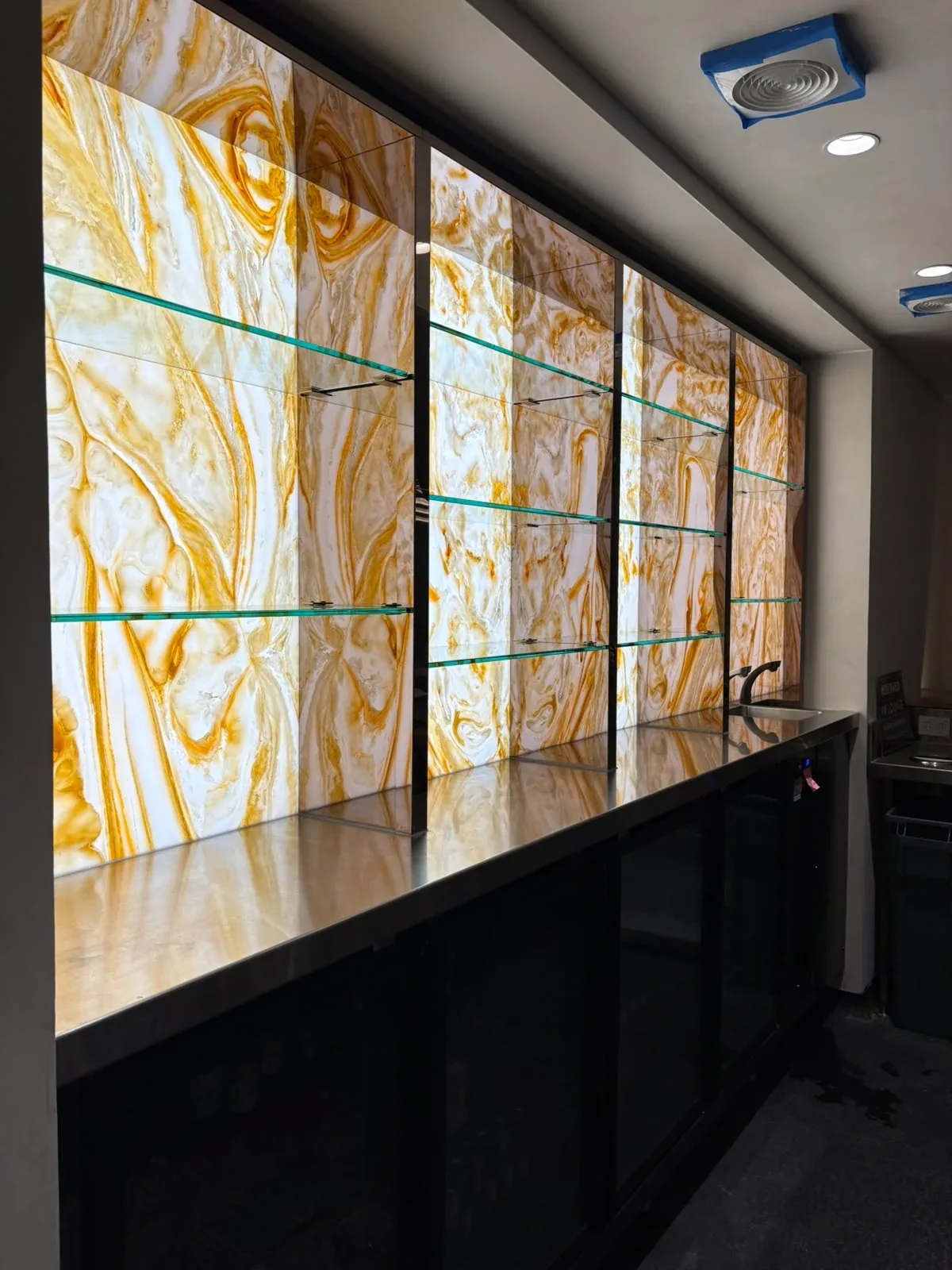 Illuminated architectural glass detail completed by All Set Electrical