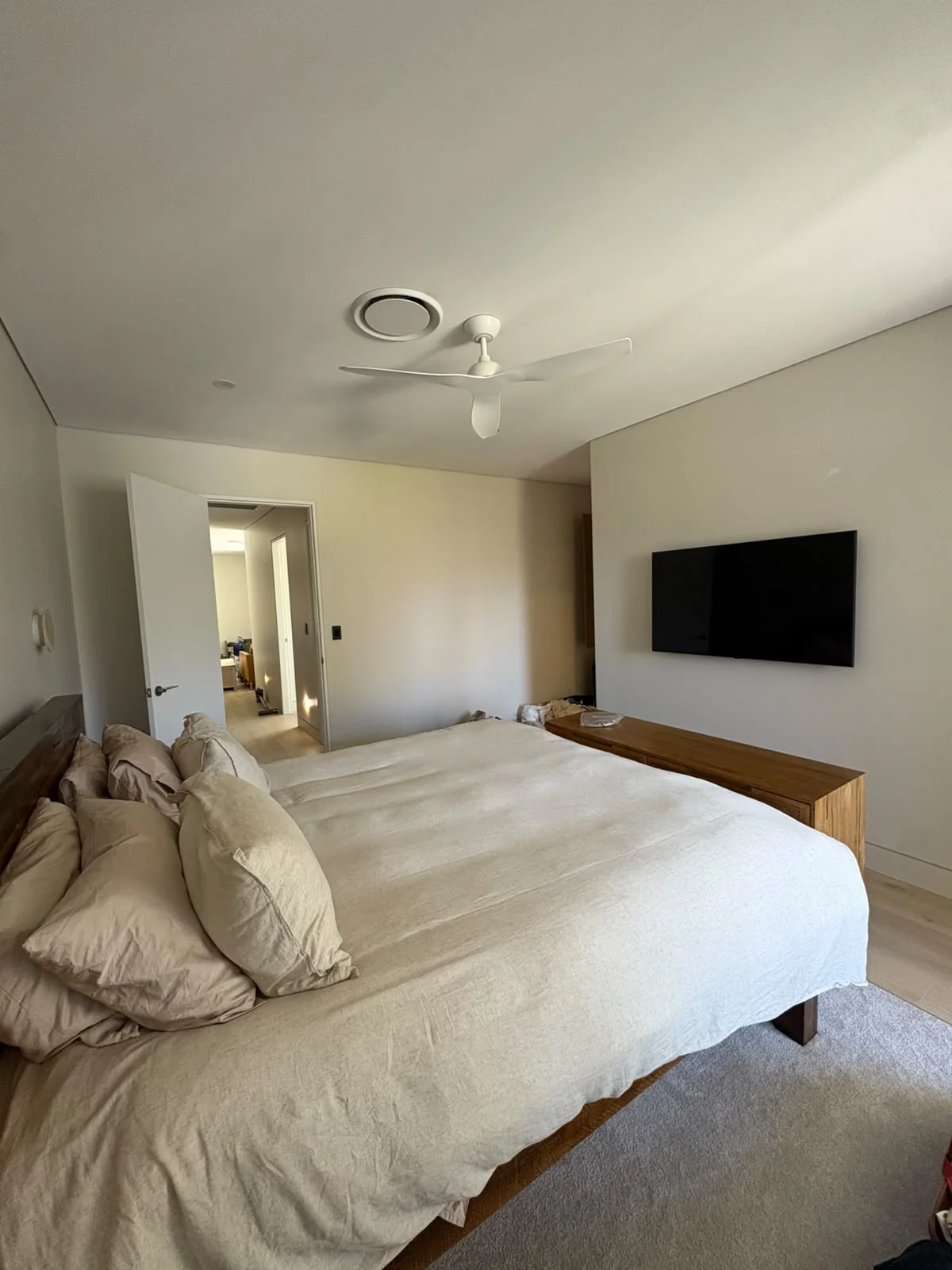 Bedroom ceiling fan and wall-mounted TV installed by All Set Electrical